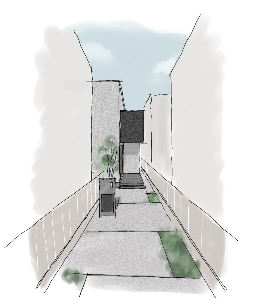 Narrow city alley between tall gray buildings, with a small planter and green shrub near the path and a dark rectangular sign mounted on a wall.